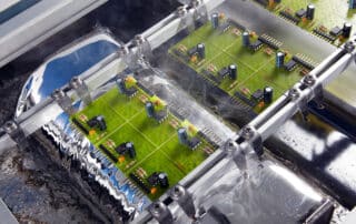 electronic assemblies in a wave soldering machine